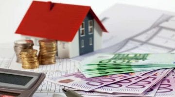 Feature | money and miniature house | What Is A Property Tax Calculator?