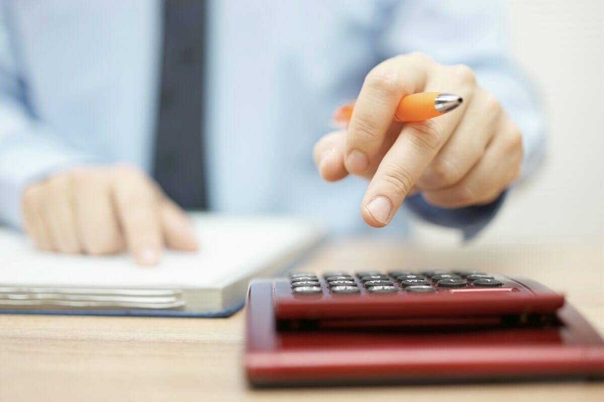 person using calculator | Are Bonuses Taxed Differently Than Commissions? | Tax Rate on Bonuses | tax rate on bonuses | tax cut bonuses