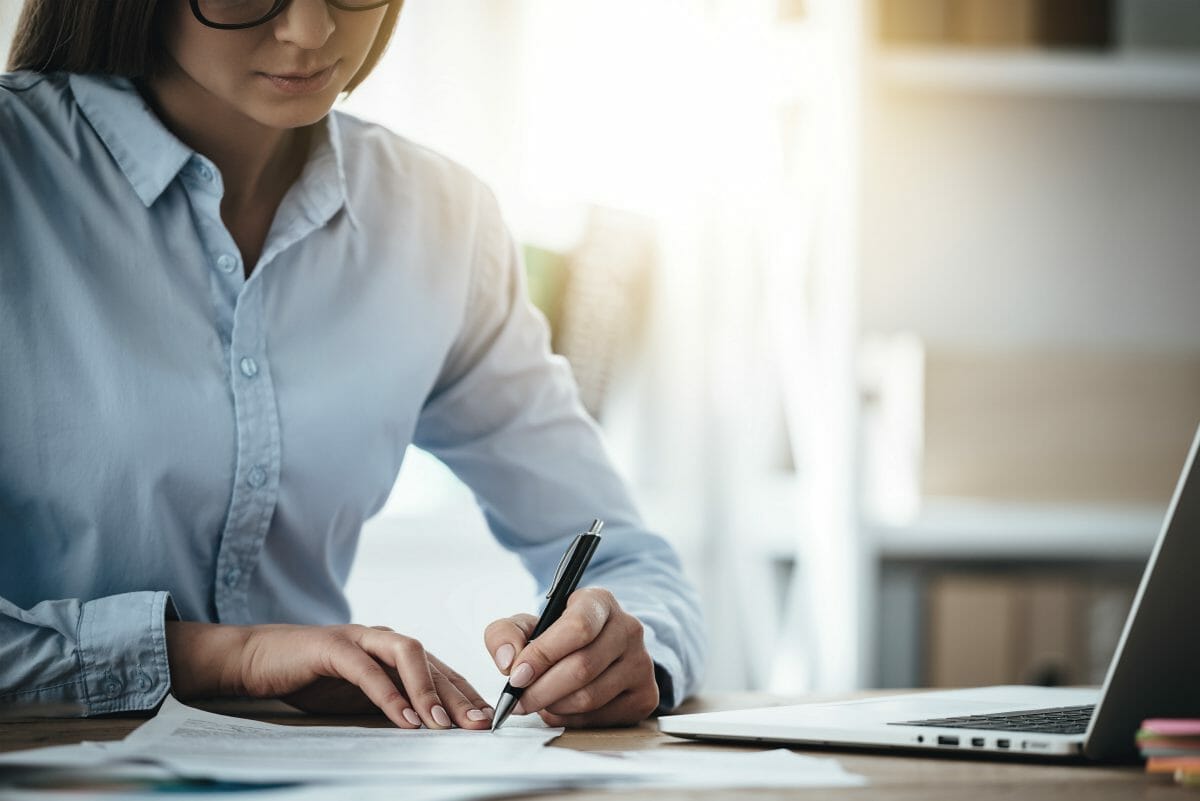 woman signing document | IRS Form 2848 [Report Power Of Attorney] | Internal Revenue Service | form 2848 instructions