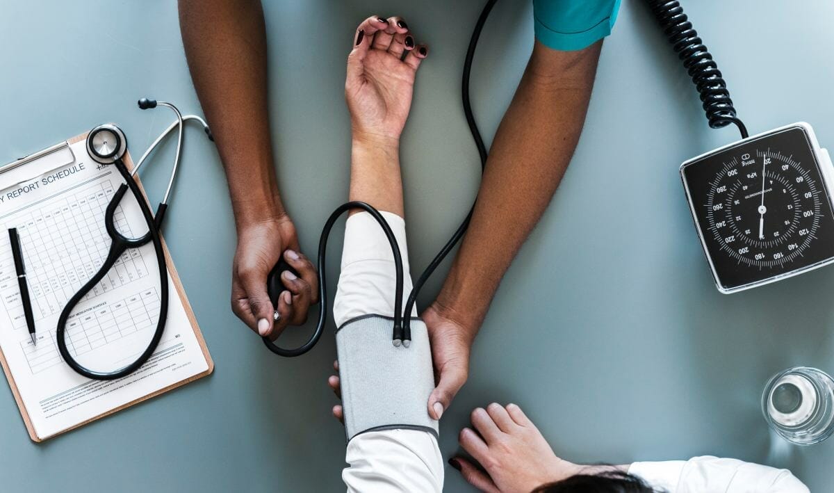 nurse checking patient's blood pressure | No Health Insurance Penalty | Everything You Need To Know