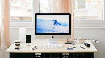 Feature | desktop on a table by the window | How To Write Off Taxes For Home Offices | expenses from business use of home