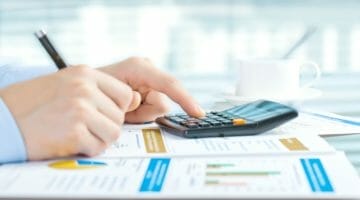 Feature | person using calculator | What Is Financial Planning? Frequently Asked Questions [And Answers!] | financial control