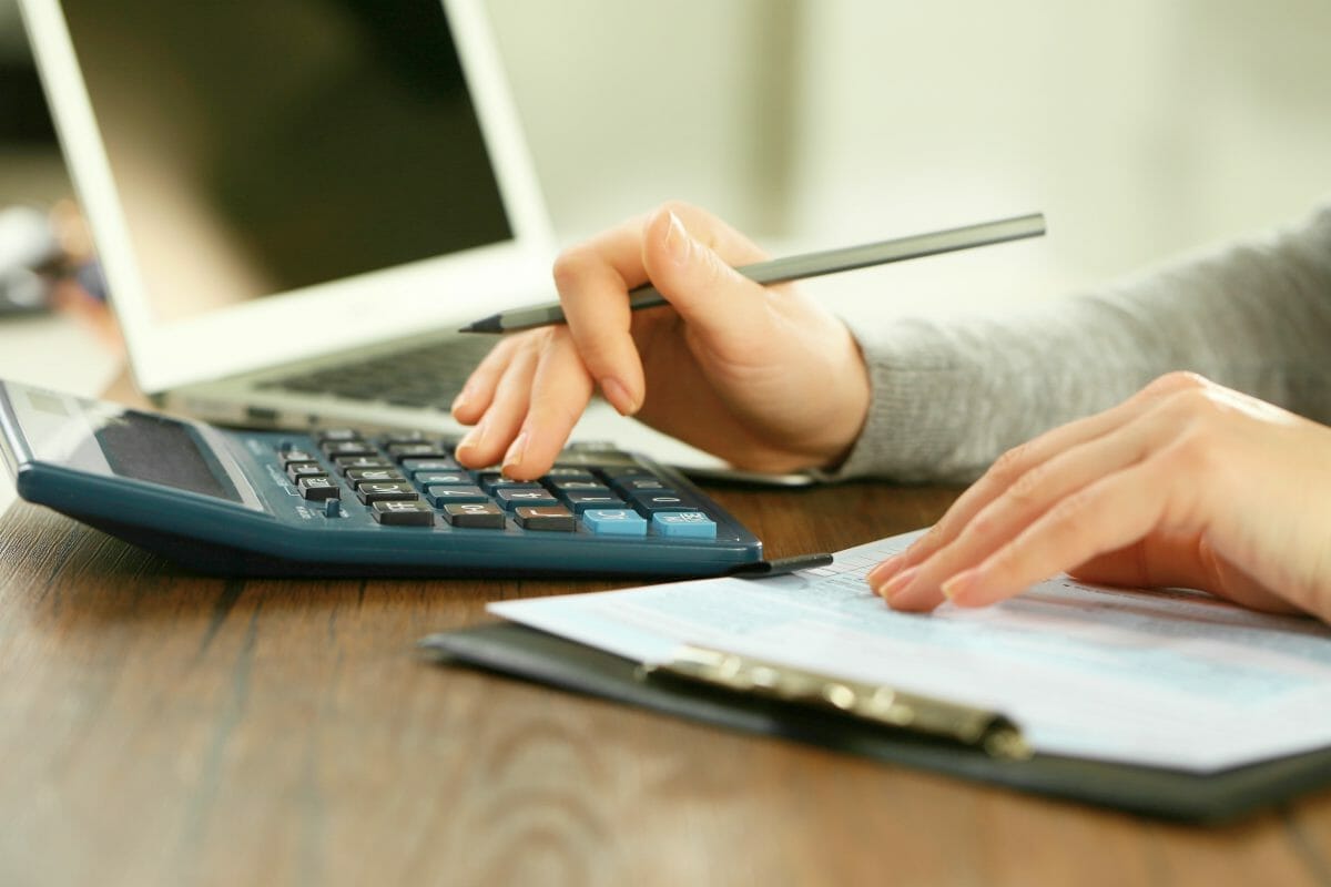 female hand using calculator | Tax Deductions and Tax Writeoffs Guide | Tax Writeoff Blog Roundup | What Is Tax Deductible?