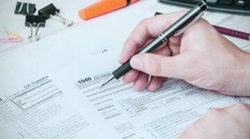 Feature | man filling out tax forms | We Break Down The New Tax Forms 1040 | Tax Forms 1040