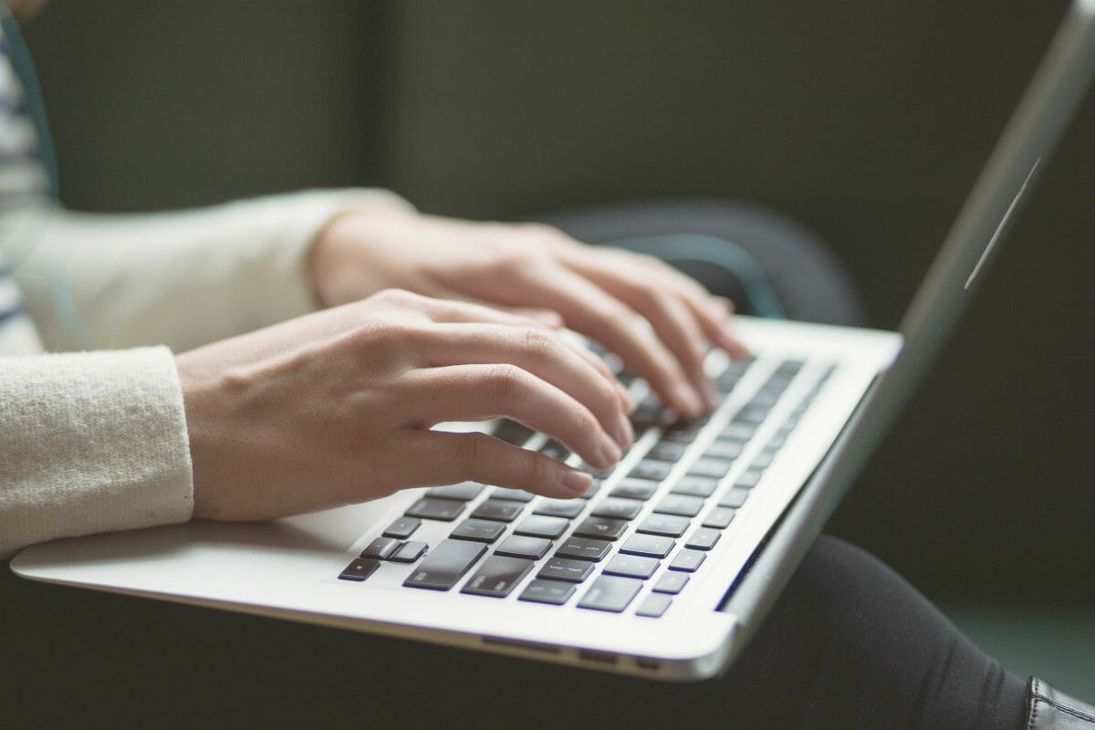 person using a laptop | IRS Scams to Watch For | Real Life IRS Tax Scam Stories