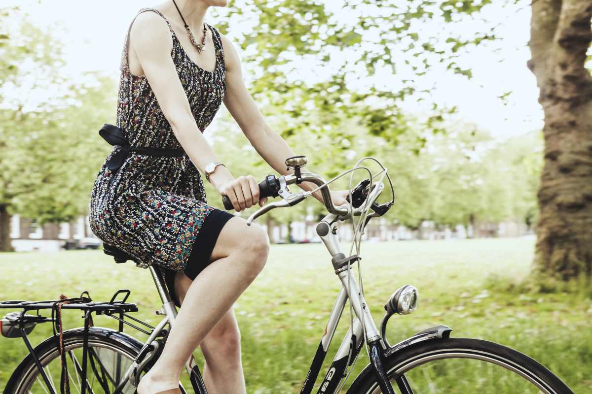 woman biking outside | Benefits Of Frugality You Need To Start Thinking About | how to be frugal