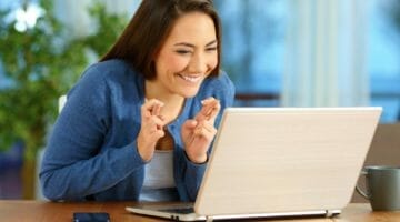 Featured | happy girl looking at laptop | Where Is My Tax Refund? Troubleshooting Tips For Receiving Your Refund | tax refund