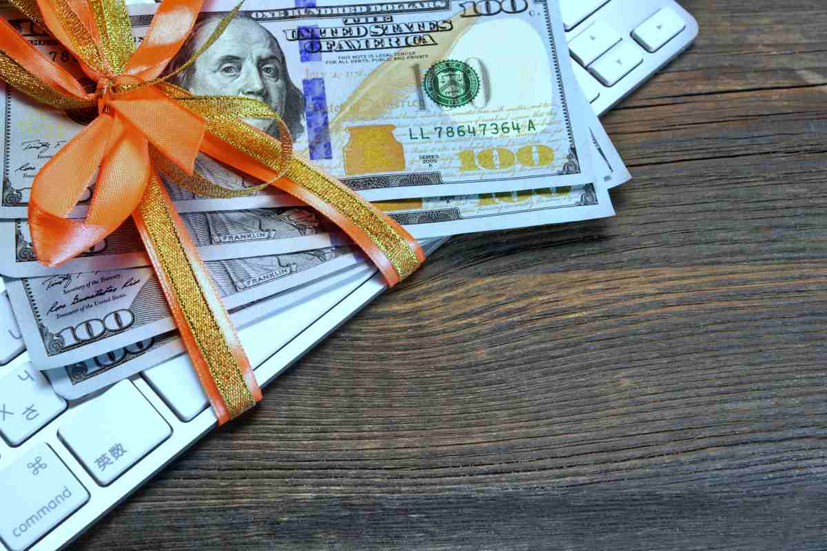 money tied ribbon on computer keyboard | IRS Rules On Gifts | gift tax