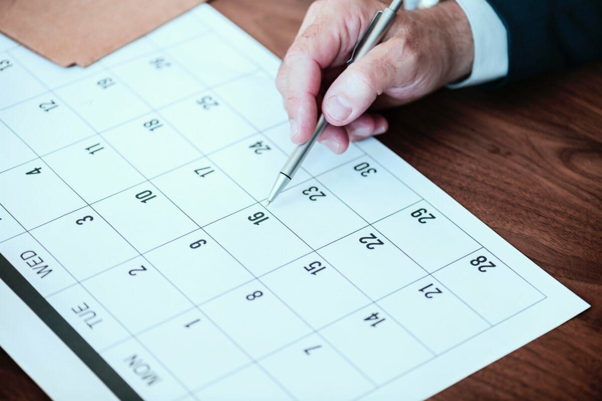 person pin pointing pen on calendar | What Happens If You Don’t Pay Taxes? | Consequences and Penalties | taxes