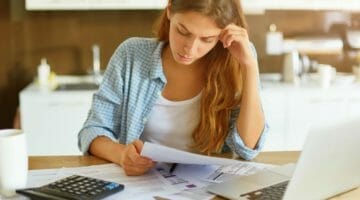 Feature | worried young single mother | What Happens If You Don’t File Taxes Annually? | what happens if you don't file taxes on time