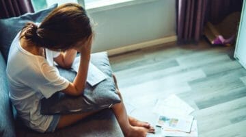 Feature | young woman worried about bills | Failure To File Penalty: Facts You Should Know | Failure to file penalty calculation