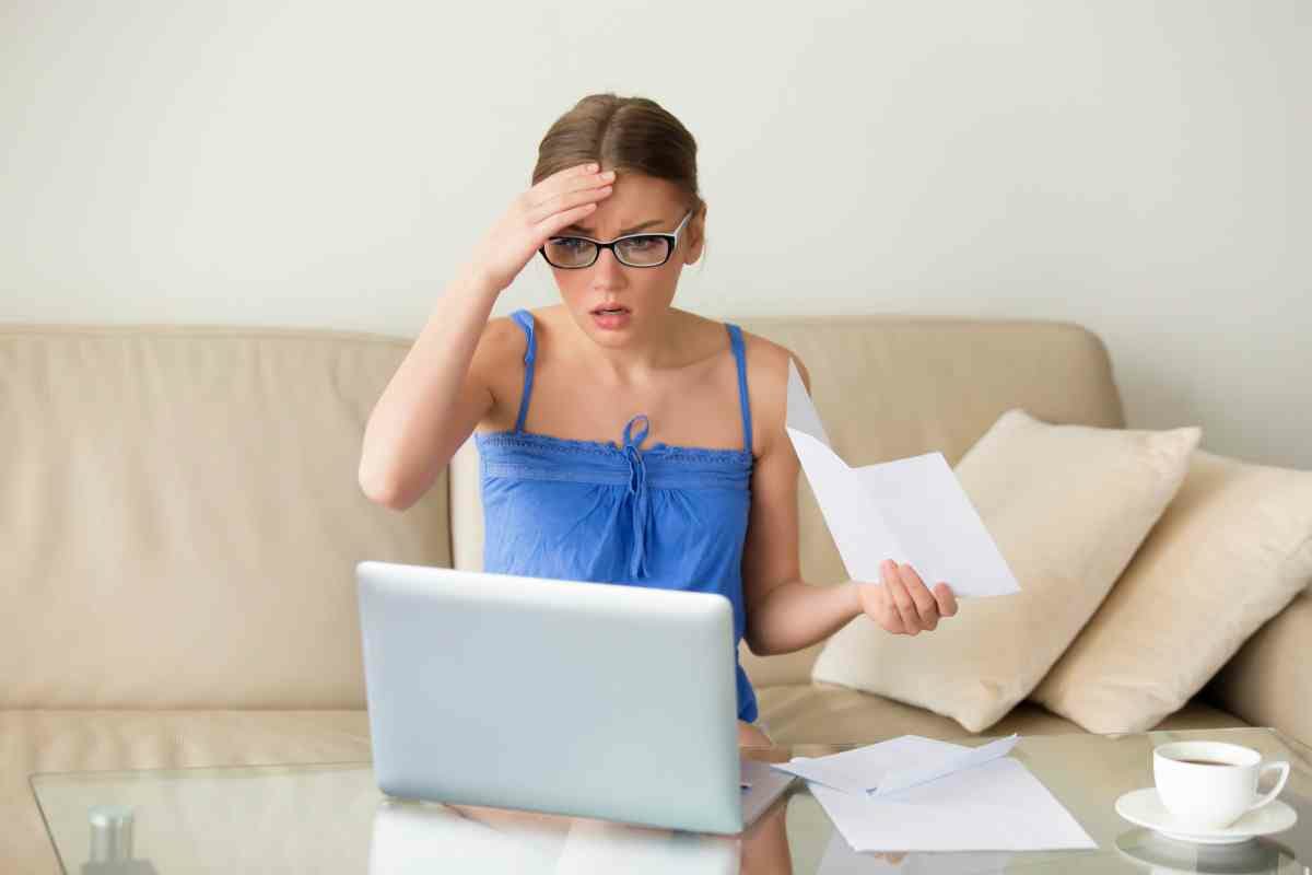 worried woman looking at her laptop | What Happens If You File Taxes Late | Frequently Asked Questions About Missing Tax Deadlines | Is there a penalty for filing late if you get a refund?