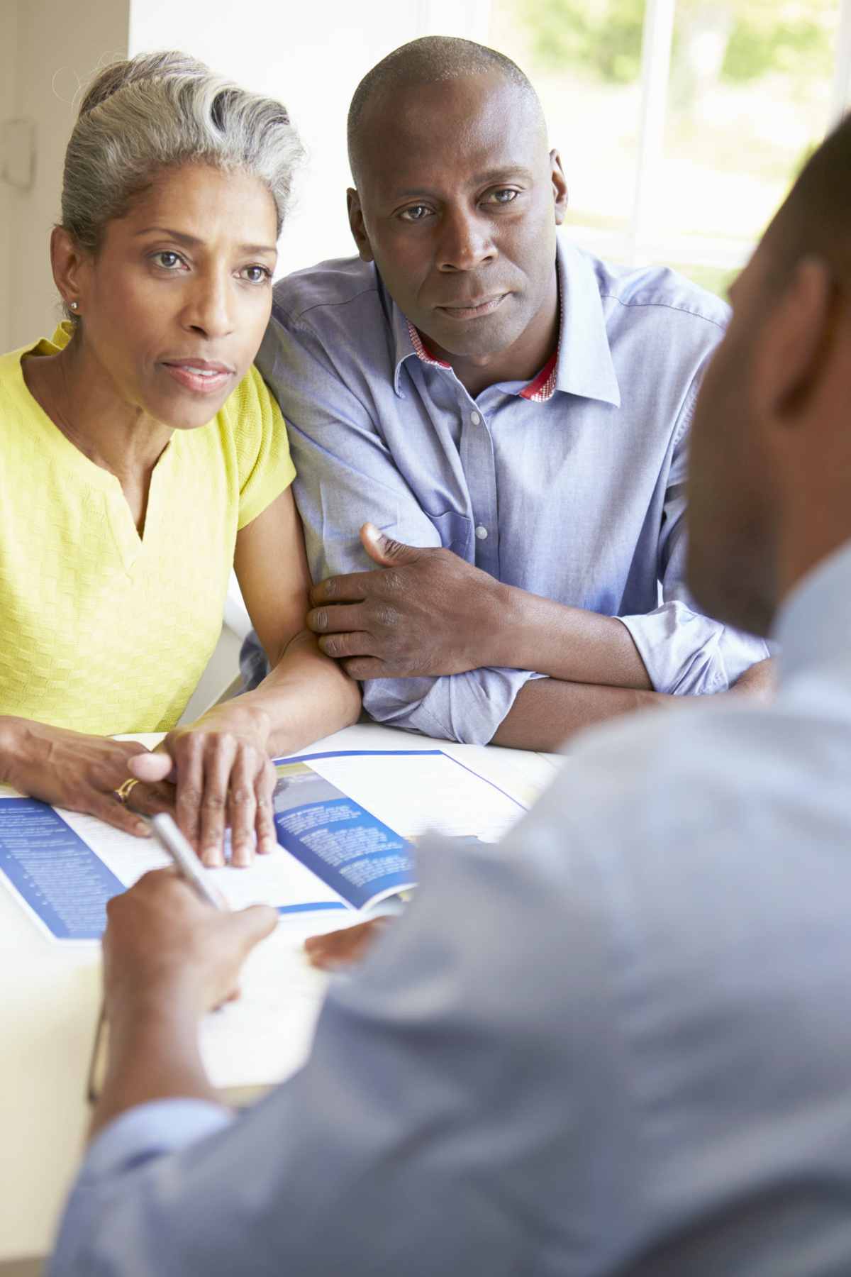  Couple talking with tax auditor | Things NOT To Say To The IRS If You Owe Back Taxes