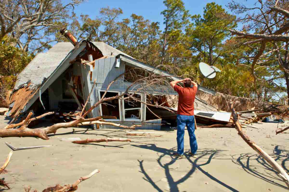 man grieving over house destroyed by flood | Penalty Abatement: Factors That Can Qualify As Reasonable Cause | What does reasonable cause mean