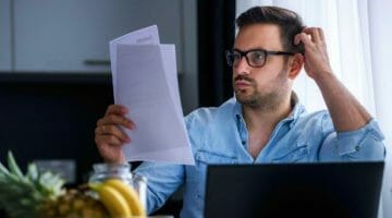 Feature | man looking at his finances | Things To Consider When Choosing An IRS Payment Plan | irs payment plan