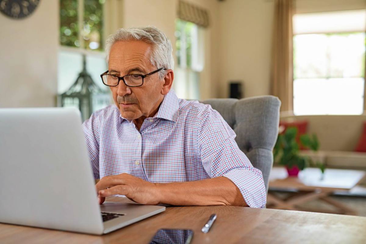 senior man on laptop | Premium Tax Credit Frequently Asked Questions | advance premium tax credit
