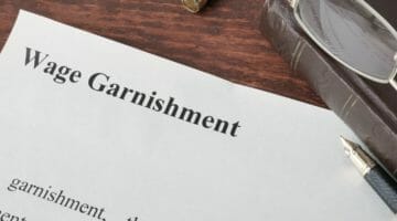 Feature | wage garnishment written on paper | Wage Garnishment Frequently Asked Questions | irs garnishment