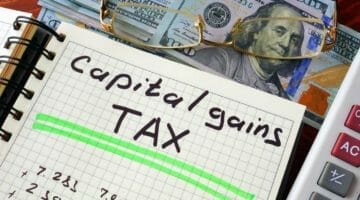 Feature | capital gains tax written on notebook | What Is Capital Gains Tax? | capital gains tax rates