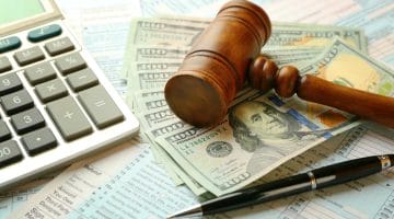 Feature | judge gavel and money | Tax Sins Not To Commit To Avoid Tax Fraud Charges | irs criminal investigation
