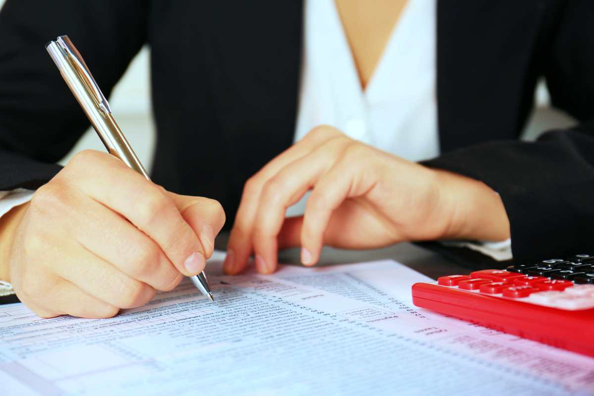 woman filling out forms | How To Deal With The IRS Regarding Cancellation Of Debt | 1099-c 