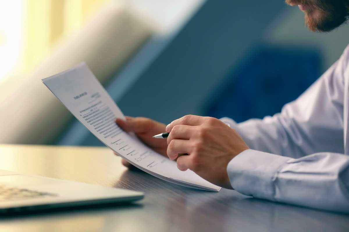 businessman reading documents | How To Deal With The IRS Regarding Cancellation Of Debt | 1099-c cancellation of debt