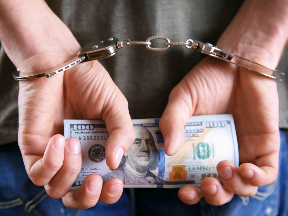 man handcuffs holding money | IRS Penalties You Could Be Facing After An Audit | irs penalty