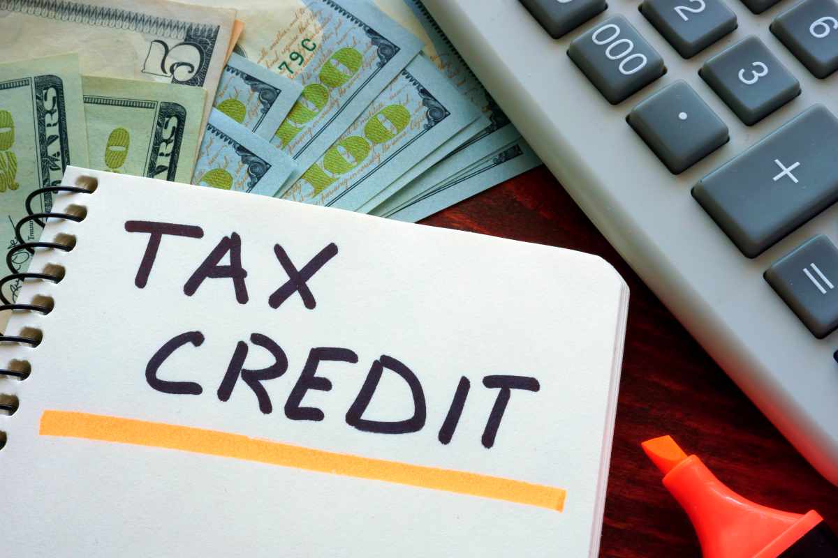 tax credit on notebook | Reasons To Speak To A Tax Relief Specialist About Your Back Taxes ASAP | tax relief companies