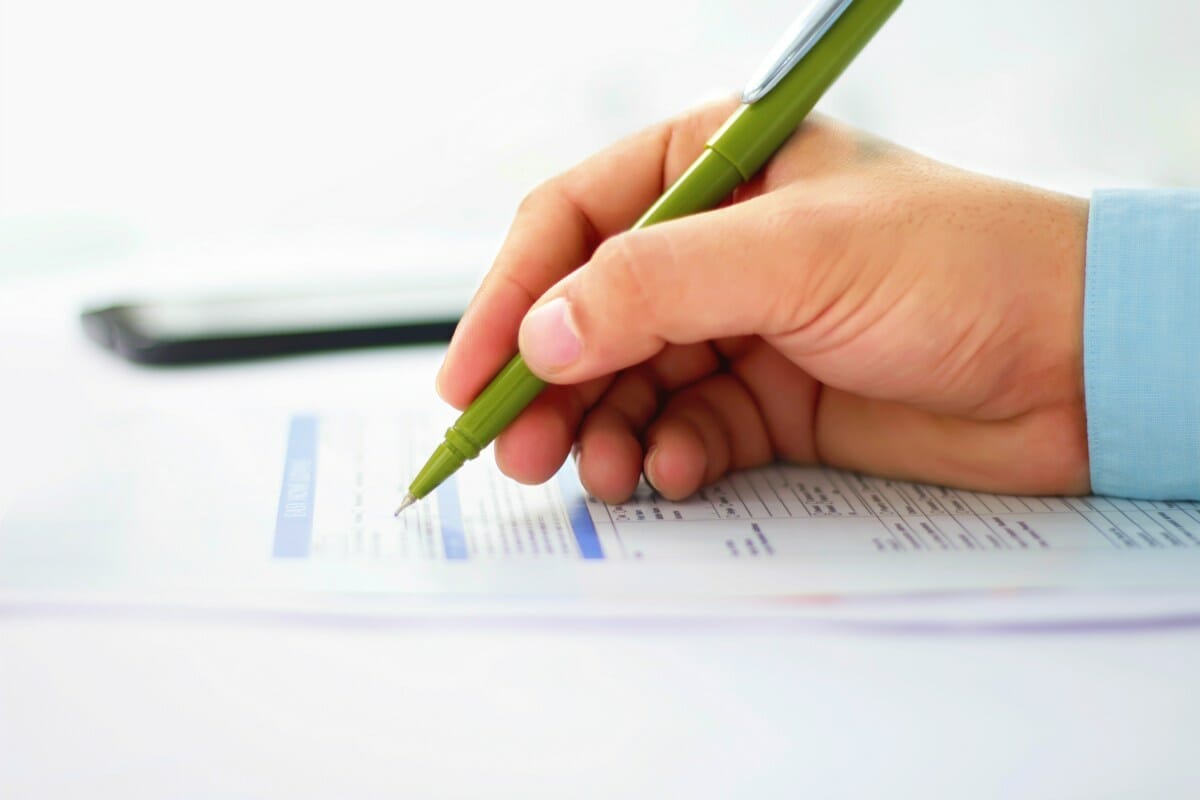 person filling out form | Tax Worries You May Have And The Solutions For Each [FAQs]