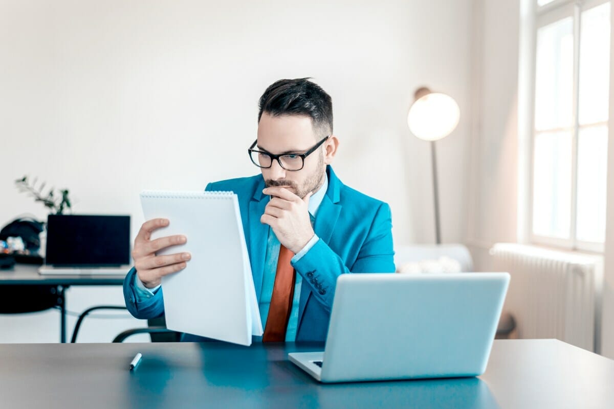 serious man reading document | How To Dispute An Incorrect IRS Tax Liability | irs dispute