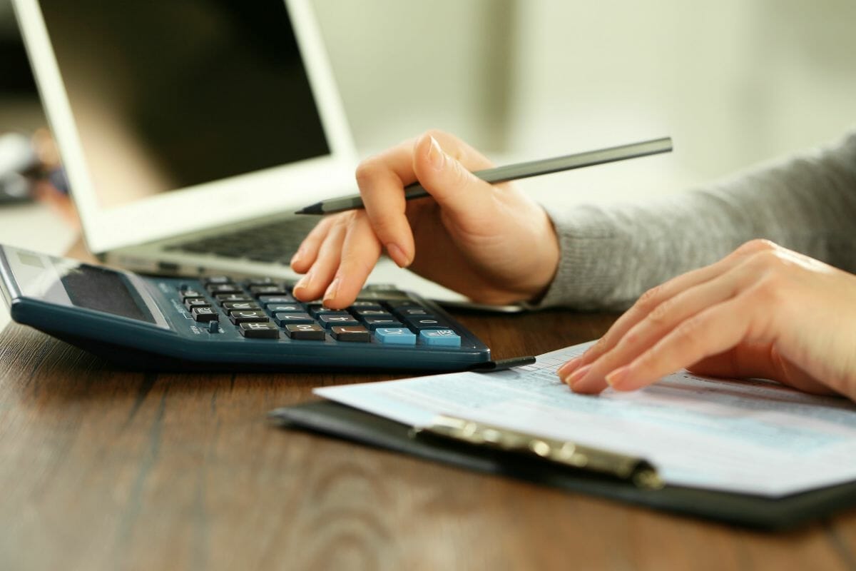 person using calculator | A Guide To Estimated Taxes For Small Business Owners | pay estimated taxes 