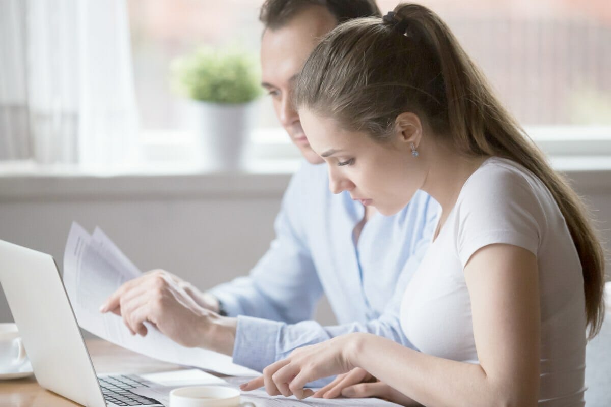 young couple reading documents | IRS Further Expands The Tax Underpayment Penalty Relief | underpayment penalty rate