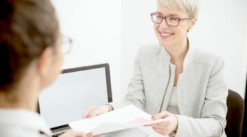 Feature | two women talking | How To Prepare For A Tax Audit | Worker Classification | irs audit