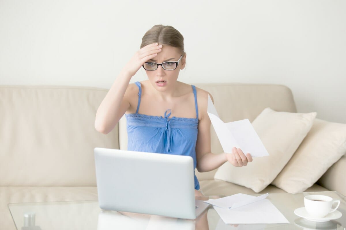 worried woman looking at laptop | IRS Further Expands The Tax Underpayment Penalty Relief | penalty for underpayment of estimated tax