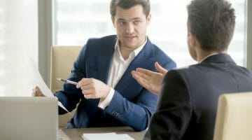 Feature | two businessmen talking | How To Get An Offer In Compromise Approved | Tips | Tax Relief Center | irs offer in compromise tips