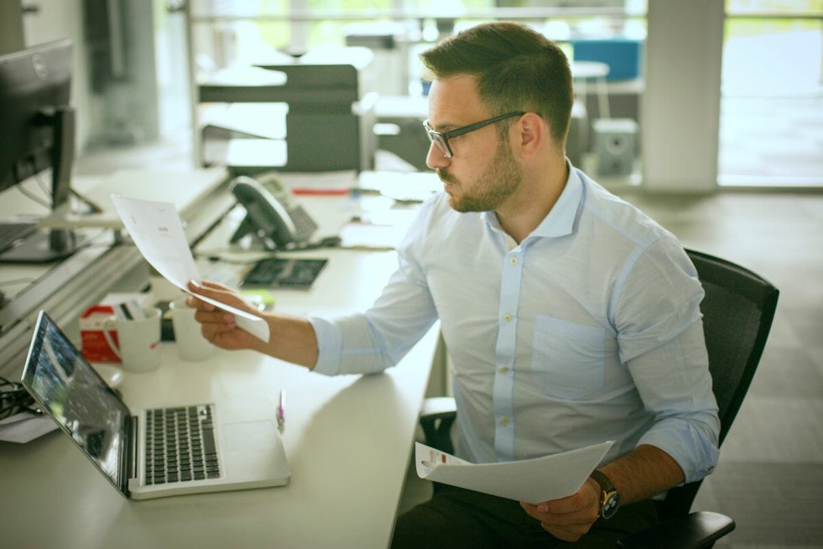 man reading document | What Is The IRS Employee Misclassification Amnesty Program? | misclassification