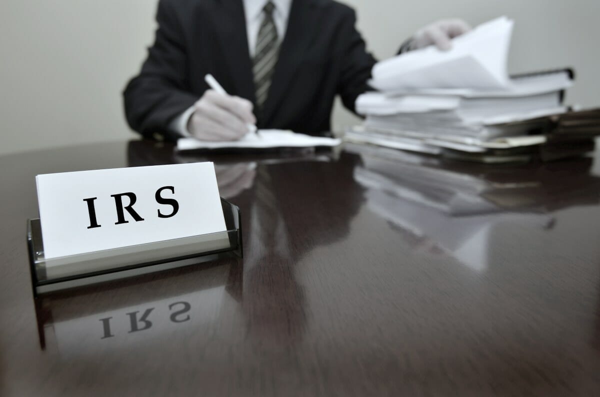 IRS tax auditor working | Failure To Deposit: IRS 941 Late Payment Penalties | 941 late payment penalty | irs late payment interest rate | irs late payment penalty