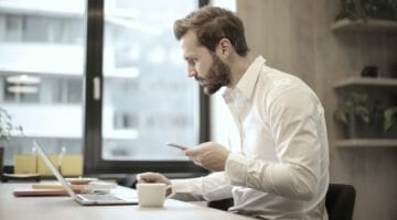 man looking at his laptop | The Difference Between Sales Tax and Use Tax | use tax | what is sales and use tax | Featured